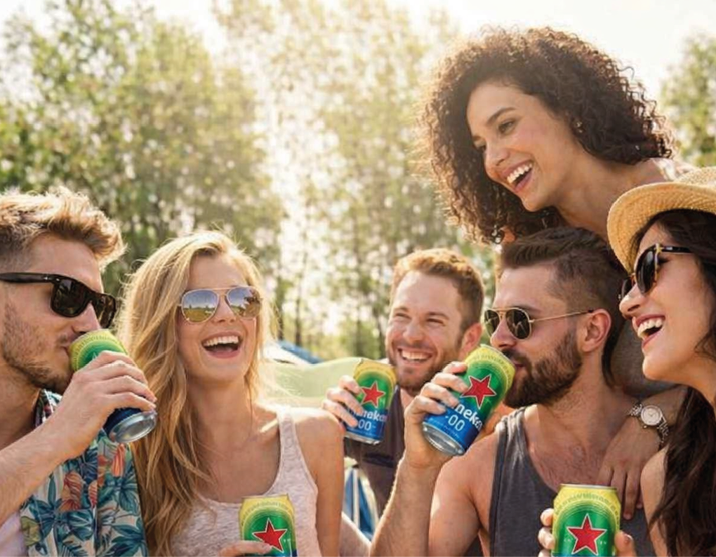 A group of people sitting on a blanket, drinking beer. Description generated by AI