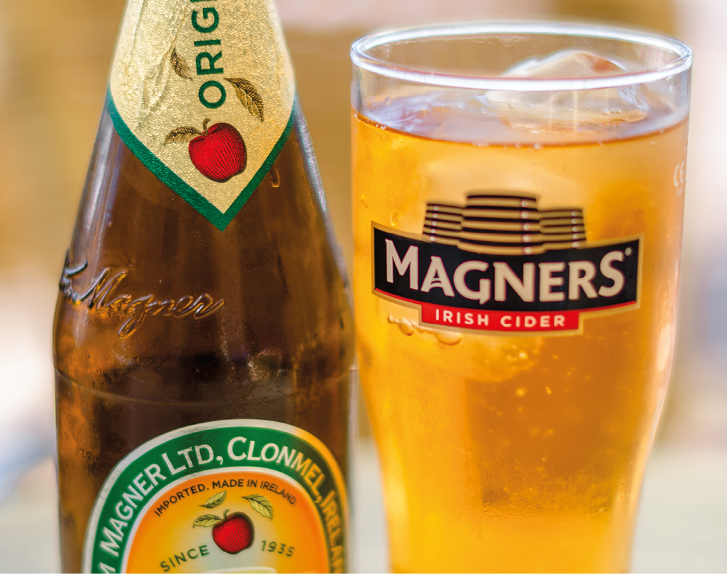 FUENGIROLA, SPAIN - OCTOBER 10, 2021: Bottle of Magners Irish Cider, served chilled in a Magners logo glass