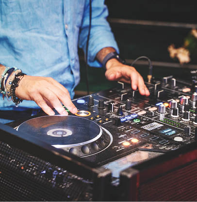 A DJ mixing music on professional DJ equipment, showcasing a vibrant and energetic nightlife scene. Ideal for music, event, and entertainment content.