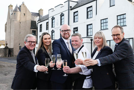 Press Eye - Belfast - Northern Ireland - 4th March 2025  Picture by  Darren Kidd / PressEye   BALLYGALLY CASTLE CELEBRATES 400 YEARS WITH £400,000 INVESTMENT…James McGinn, Managing Director of Hastings Hotels; Ballygally Castle’s Katie Jackson, Events Manager; Scott Weatherup, General Manager; Kevin Osborne, Executive Head Chef; Norma Craig, Restaurant Manager and Chairman of Hastings Hotels, Howard Hastings are pictured as the leading hotel celebrates 400 years. As part of the festivities, the property is due to complete a £400,000 investment programme later this month ahead of a programme of events and festivities which are set to take place throughout 2025.  