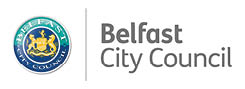 The logo of Belfast City Council features a circular emblem with a detailed gold crest on a blue background next to the text “Belfast City Council" in gray font. Description generated by AI