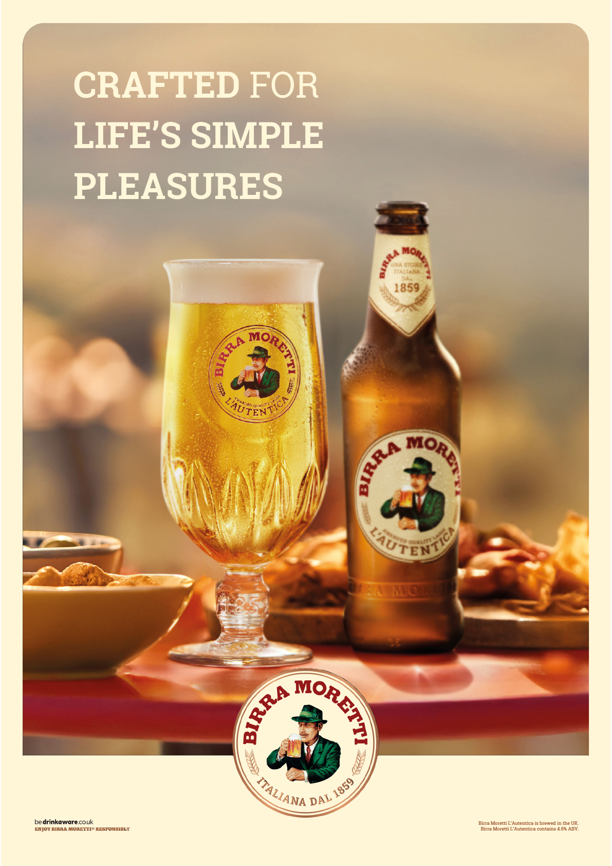 A glass and bottle of Birra Moretti beer are displayed on a table with snacks in the background and the text crafted for life's simple pleasures above. Description generated by AI