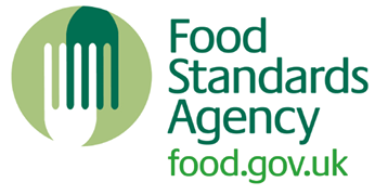 The logo for the Food Standards Agency features a stylized fork inside a green circle alongside the text “Food Standards Agency" and the website "food.gov.uk" in green and dark green font. Description generated by AI