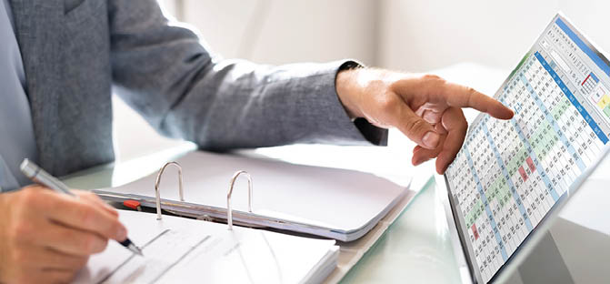 Business Billing And Electronic Spreadsheet Calculator. Accountant Using Computer