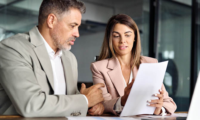 Business woman lawyer manager holding legal documents consulting mature older client at office meeting, two professional executives experts discussing financial accounting papers working together.