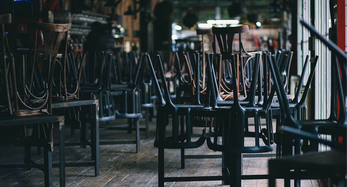 Chairs and tables stacked in a closed pub
