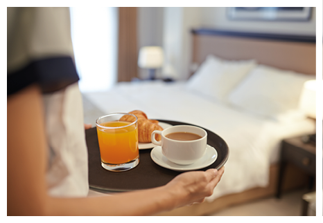 Waitress bringing breakfast to the hotel room