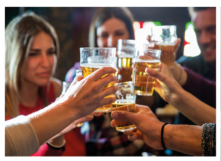 Group of happy friends having party in a bar - Young people drinking beer