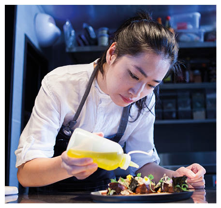 Chef dressing prepared meal