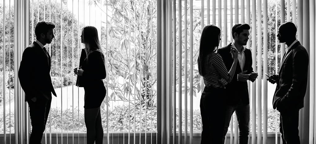 Several silhouettes of businesspeople interacting background business centrer