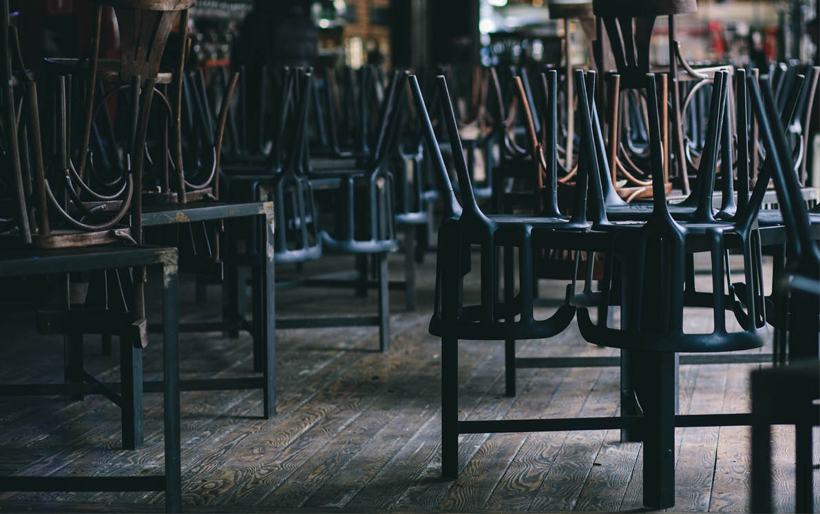 Chairs and tables stacked in a closed pub