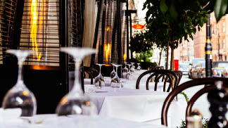 Outdoor luxury restaurant terrace tables and chairs in mayfair London with gas heater pyramid ; Shutterstock ID 613507373; Purchase Order: 8048165; Job Number / Job Name : JN 168849 Calor Patio Heater Cylinders; Client: Calor