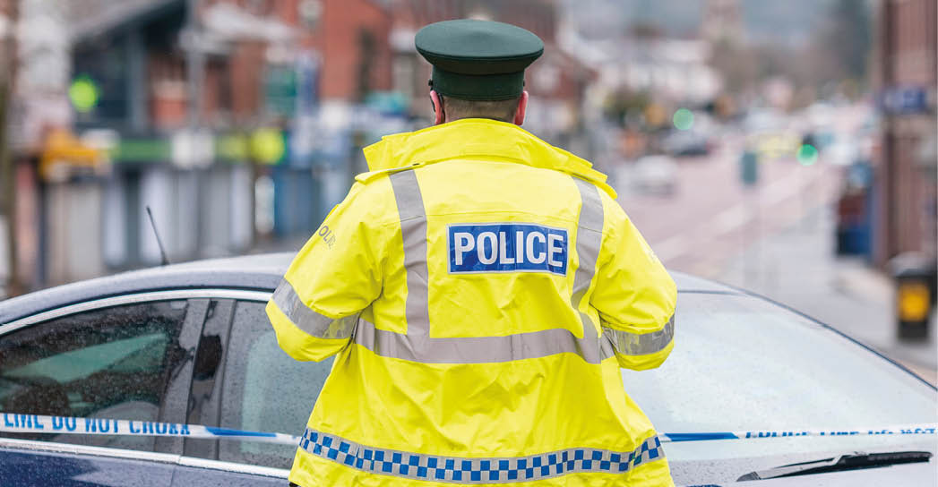 A PSNI Police Officer stands at a police cordon during a bomb alert