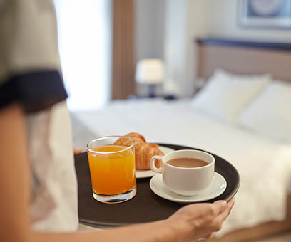Waitress bringing breakfast to the hotel room