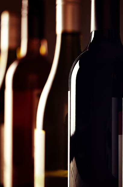 Bottles of old aged wine collection in a row in winery cellar