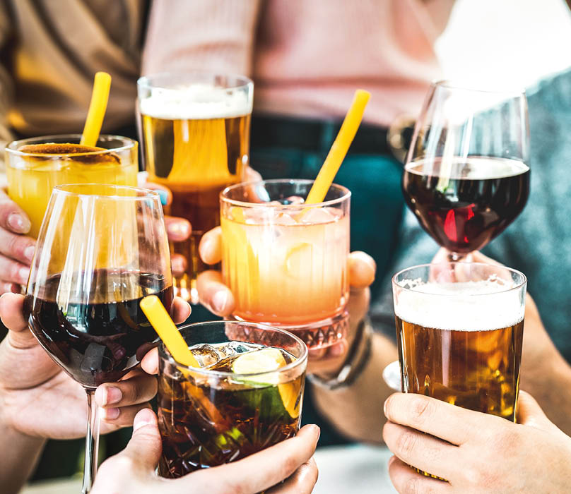 Friends hands toasting fancy cocktails - Young people having fun together drinking beer and wine at happy hour - Social life style party time concept on vivid filter - Focus on lower cuba libre drink