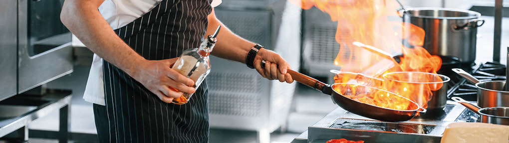 Focused on work. Chef is on the kitchen preparing food.