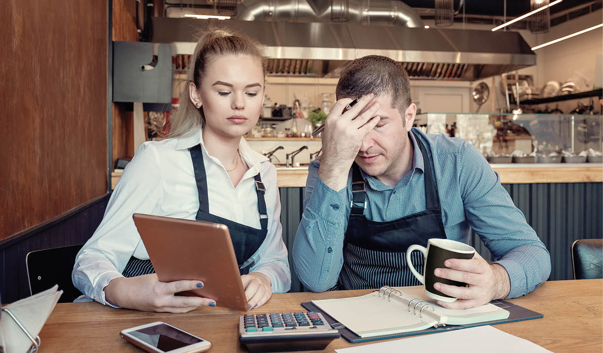 Young entrepreneurs overwhelmed by finance problems - Nervous manager checking restaurant finance - Failure in small-business concept