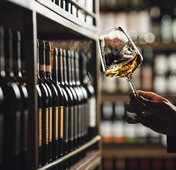 Close-Up of Sommelier Tasting White Wine in Dimly Lit Cellar